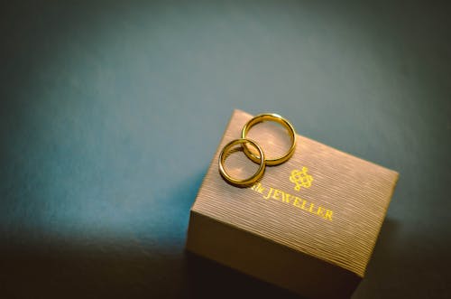 Free Gold Rings on Top pf a Brown Box Stock Photo