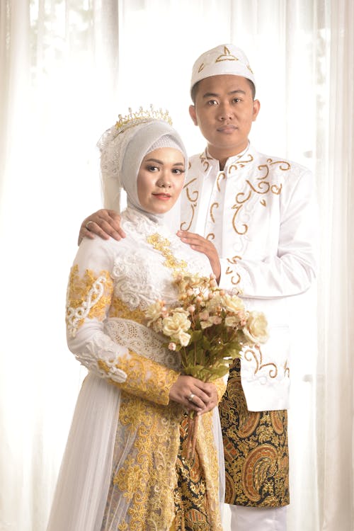 A Bride and a Woman in Traditional Wedding Dress