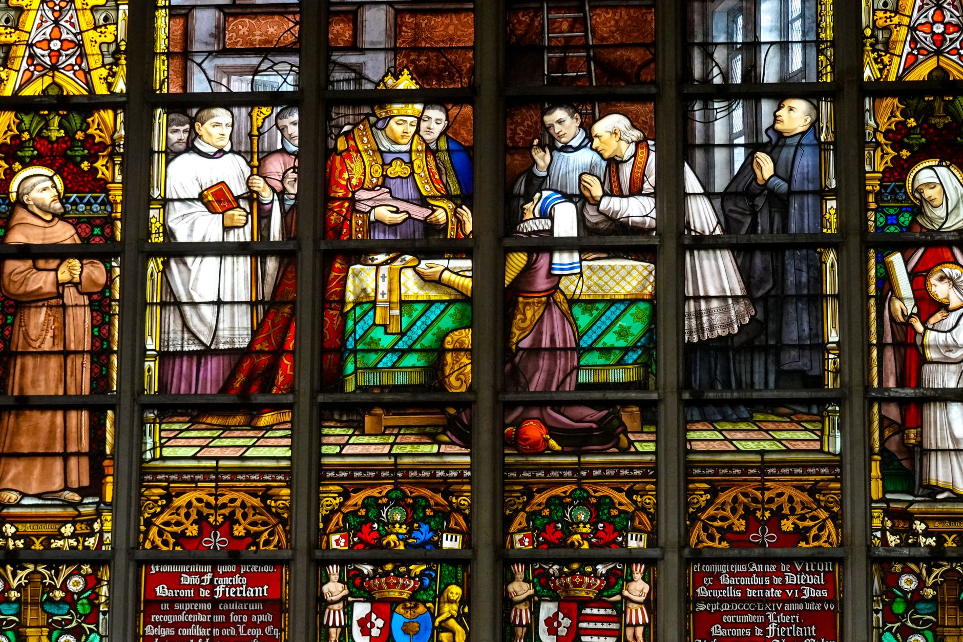 Vibrant stained glass depicting religious scenes in Cathedral of Our Lady, Antwerp.