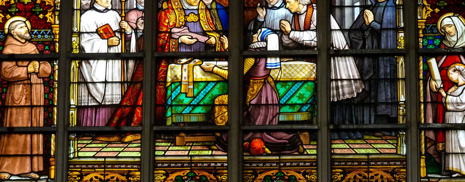 Vibrant stained glass depicting religious scenes in Cathedral of Our Lady, Antwerp.