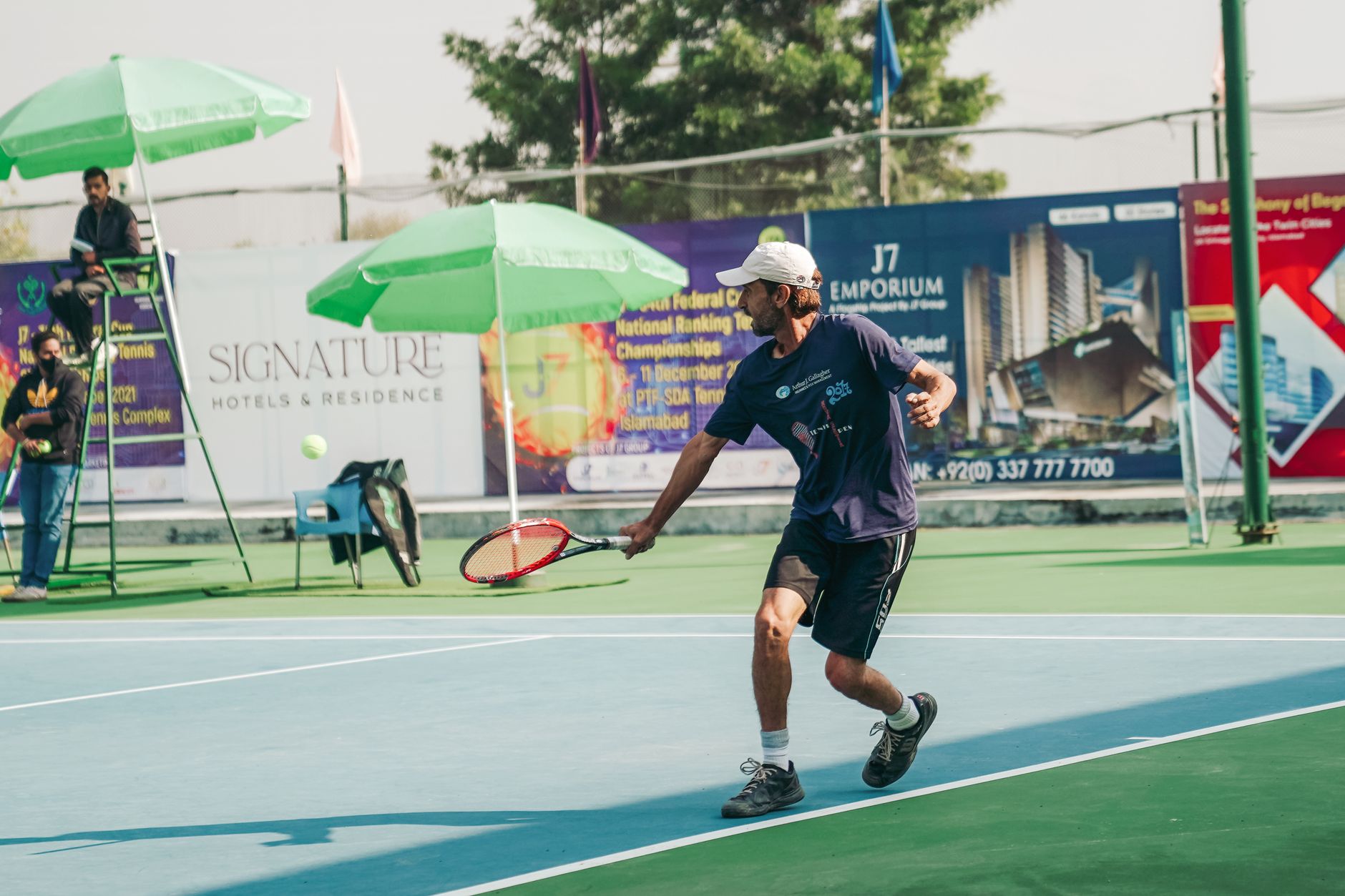 Tennis player in motion during a match on a sunny day in Islamabad. Perfect for sports and lifestyle themes.
