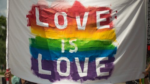 Free White and Multicolored Love Is Love Banner Stock Photo