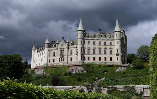 Breathtaking image of Dunrobin Castle under dramatic skies in Scotland, showcasing its historic architecture.