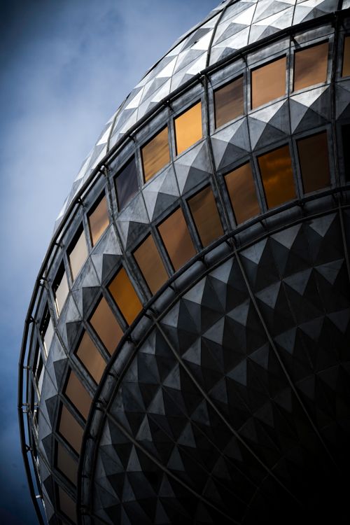 Free Dramatic close-up of the iconic Berlin TV Tower, highlighting its detailed geometric patterns against a blue sky. Stock Photo