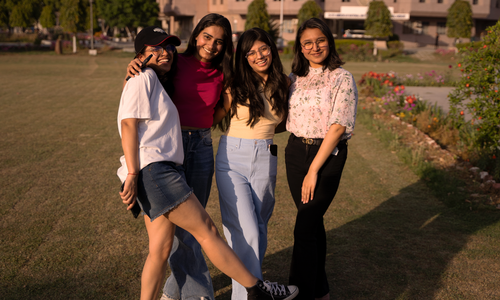 Free Smiling friends posing together in a park during a warm sunny day, showcasing vibrant styles and camaraderie. Stock Photo