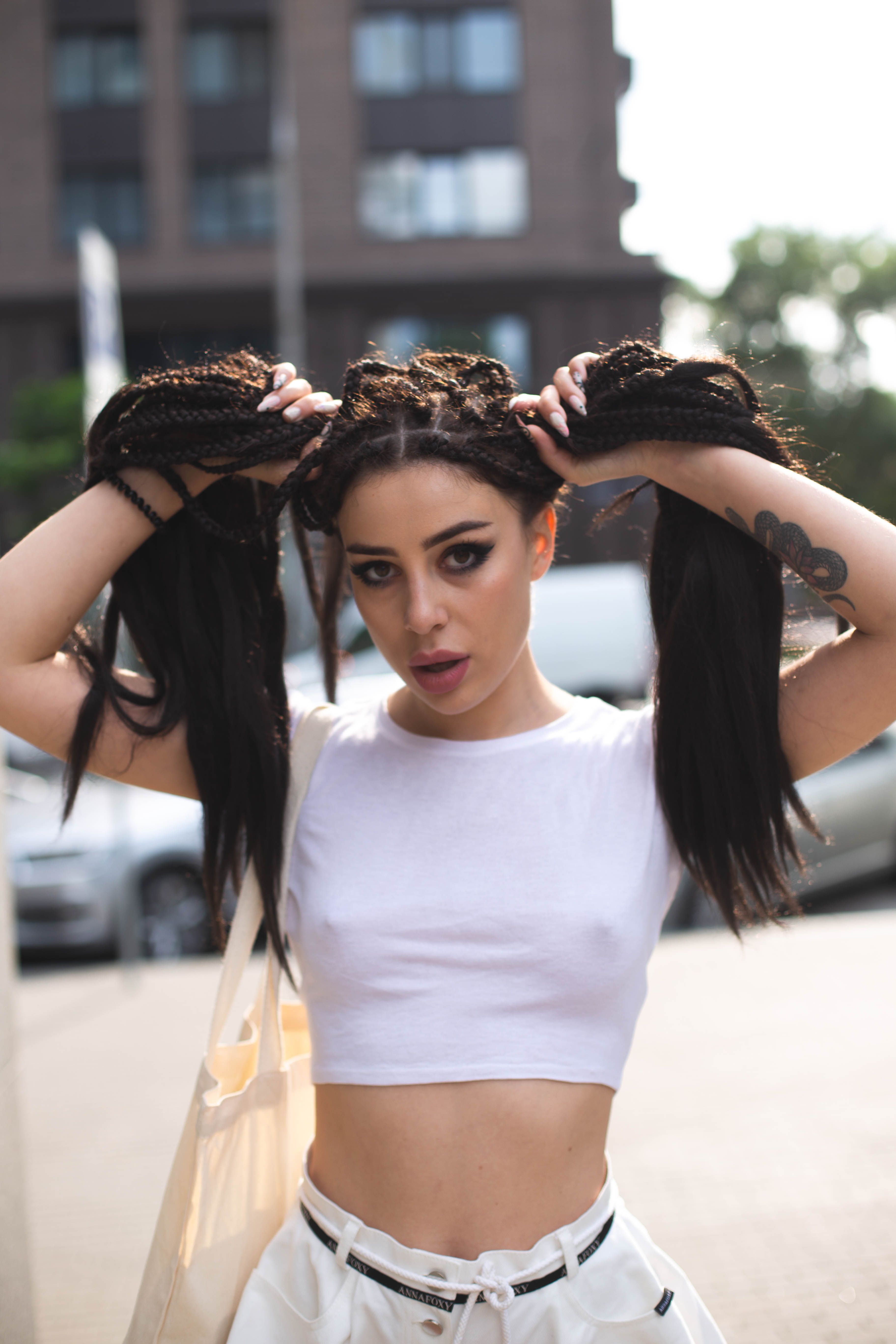 Portrait of Sexy Woman with Dreadlocks Posing on Street