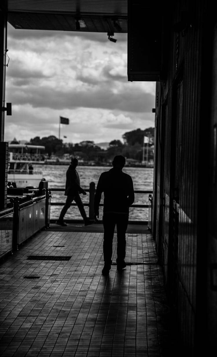 Silhouettes Of People In Port