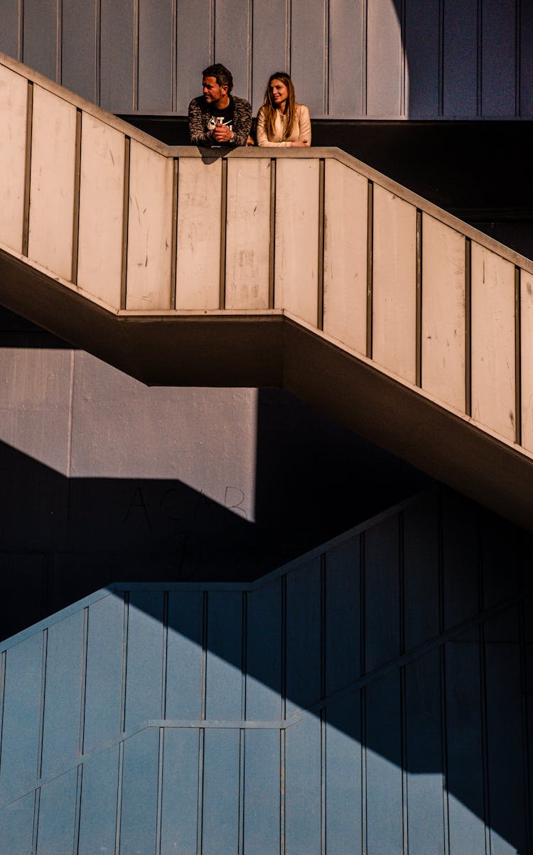 Man And Woman Standing On The Stairs 