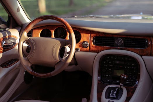 Elegant car interior featuring wooden accents and a stylish steering wheel.