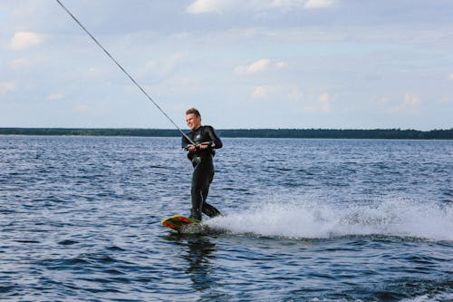 Free Man in a Wetsuit Wakeboarding Stock Photo