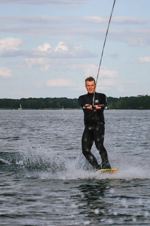 Free Man in Wetsuit Wakeboarding Stock Photo