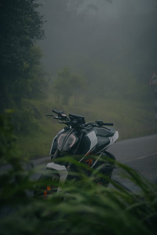 Motorcycle Parked on Asphalt Road