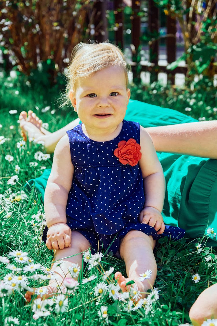 Cute Baby Girl Sitting On Grass