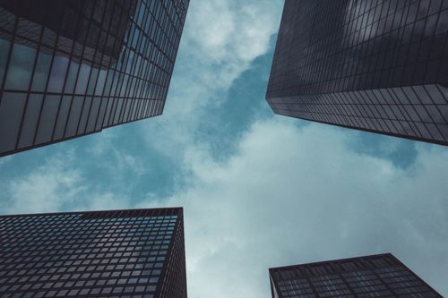 Free Low angle view of modern skyscrapers in New York City against a cloudy sky. Stock Photo