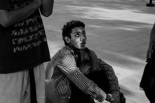Free A man sits contemplatively on the floor, captured in black and white, Monterrey. Stock Photo