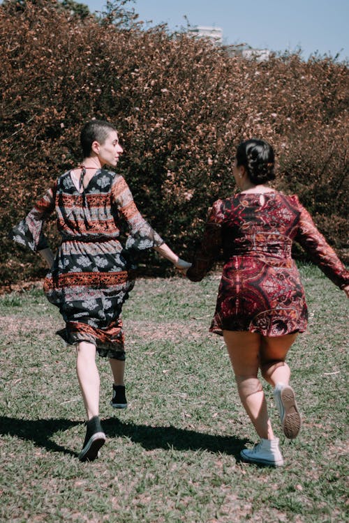 Women Holding Hands While Running