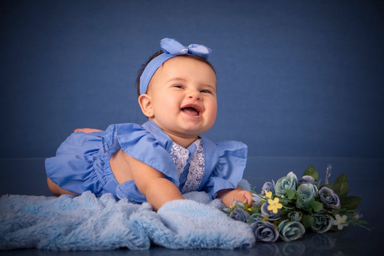 Smiling Cute Newborn Baby Posing On Studio