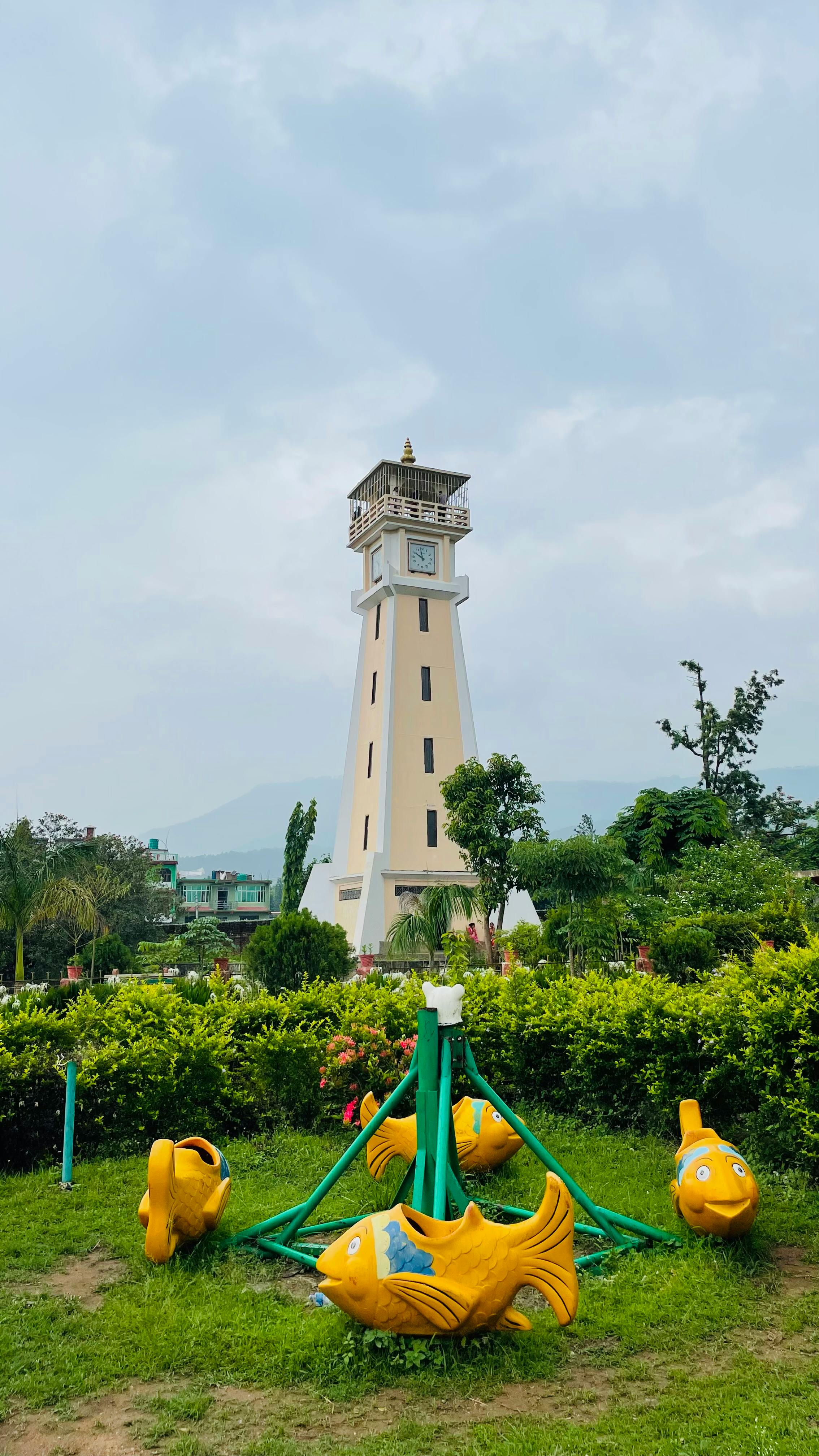 Scenic park with a prominent tower and vibrant playground equipment.