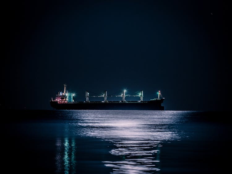 Cargo Ship On Sea At Night