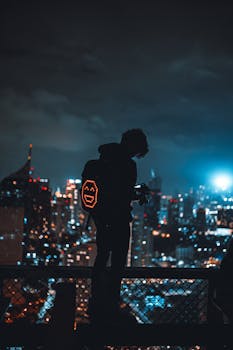 Silhouette of a man with a digital backpack on a rooftop, overlooking a vibrant city skyline at night.
