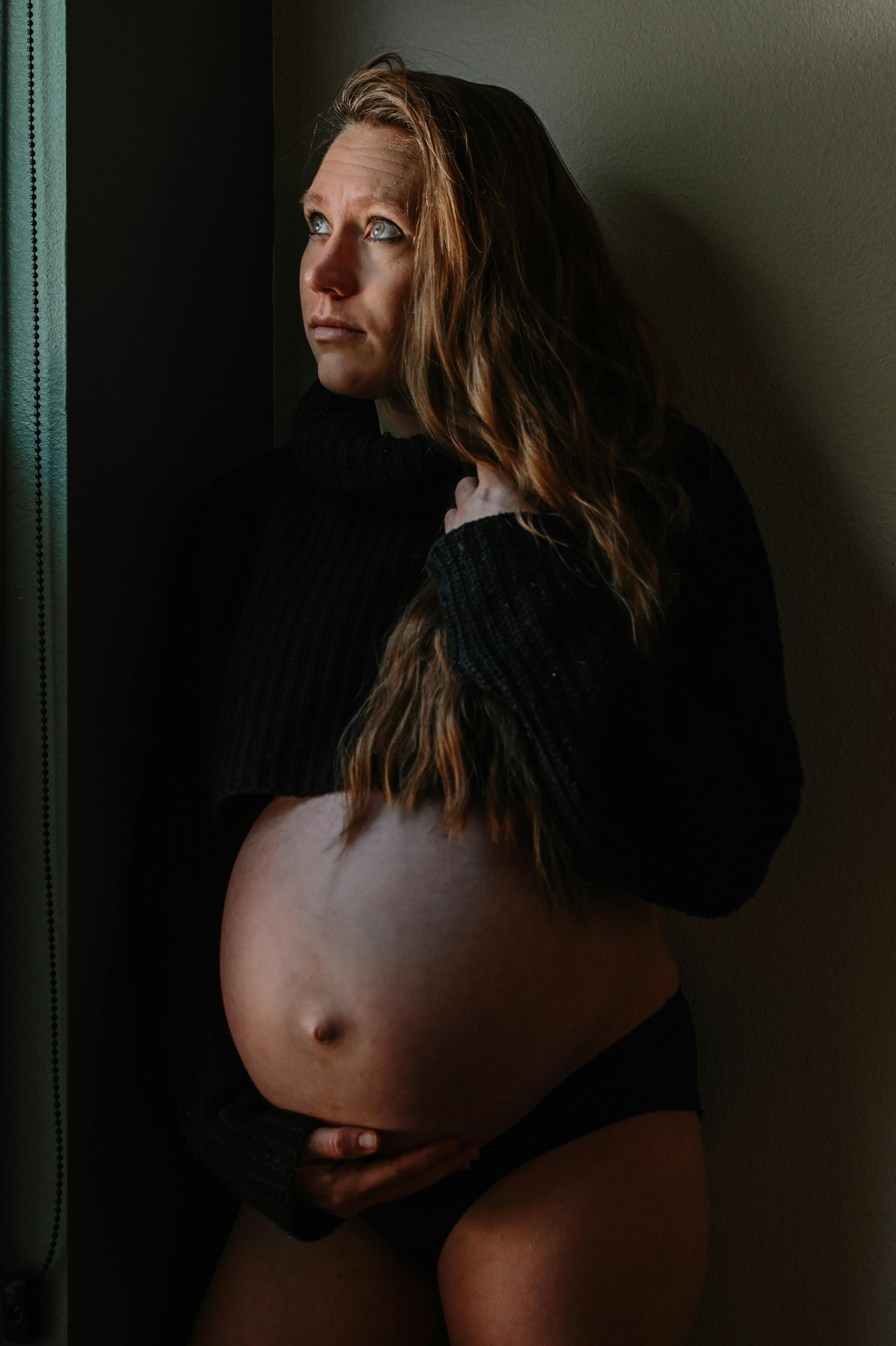 A Pregnant Woman Holding Her Belly · Free Stock Photo photo