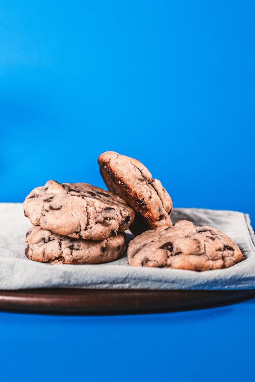 Free Delicious Chocolate Chip Cookies Placed on a Plate with Gray Cloth Stock Photo