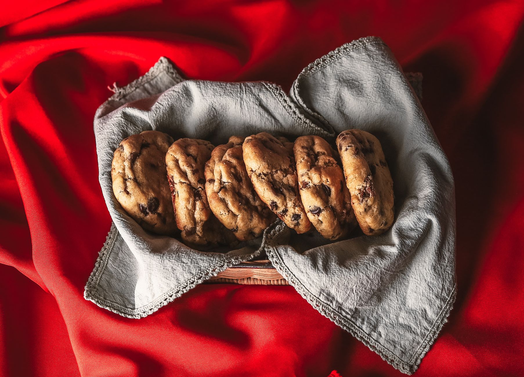 Freshly baked sourdough chocolate chip cookies on a cooling rack
