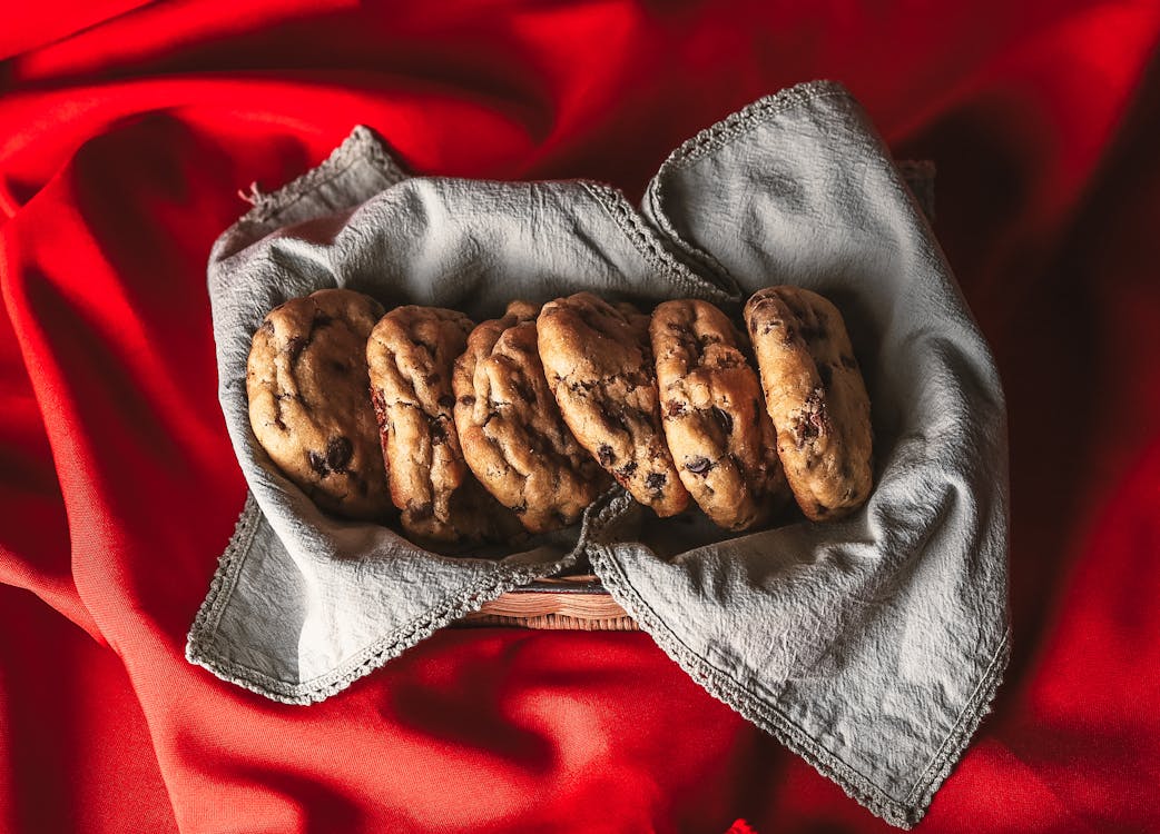 Chocolate Chip Cookies Placed in a Basket with Gray Cloth