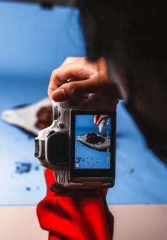 Photographer capturing a gourmet dessert with a camera, perfect for culinary and lifestyle themes.