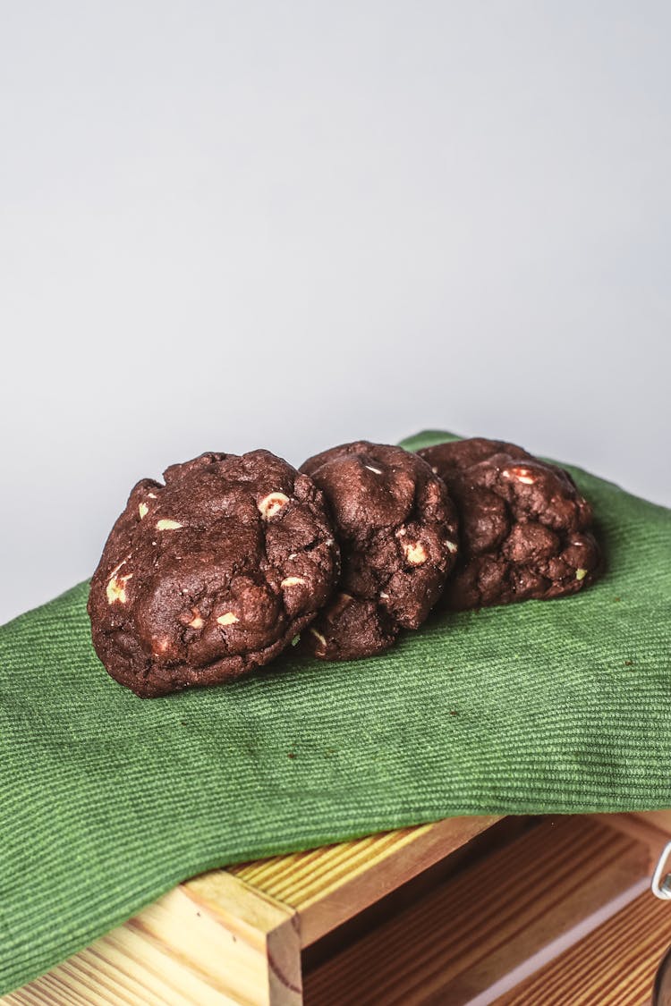 Three Chocolate Cakes On Green Tablecloth