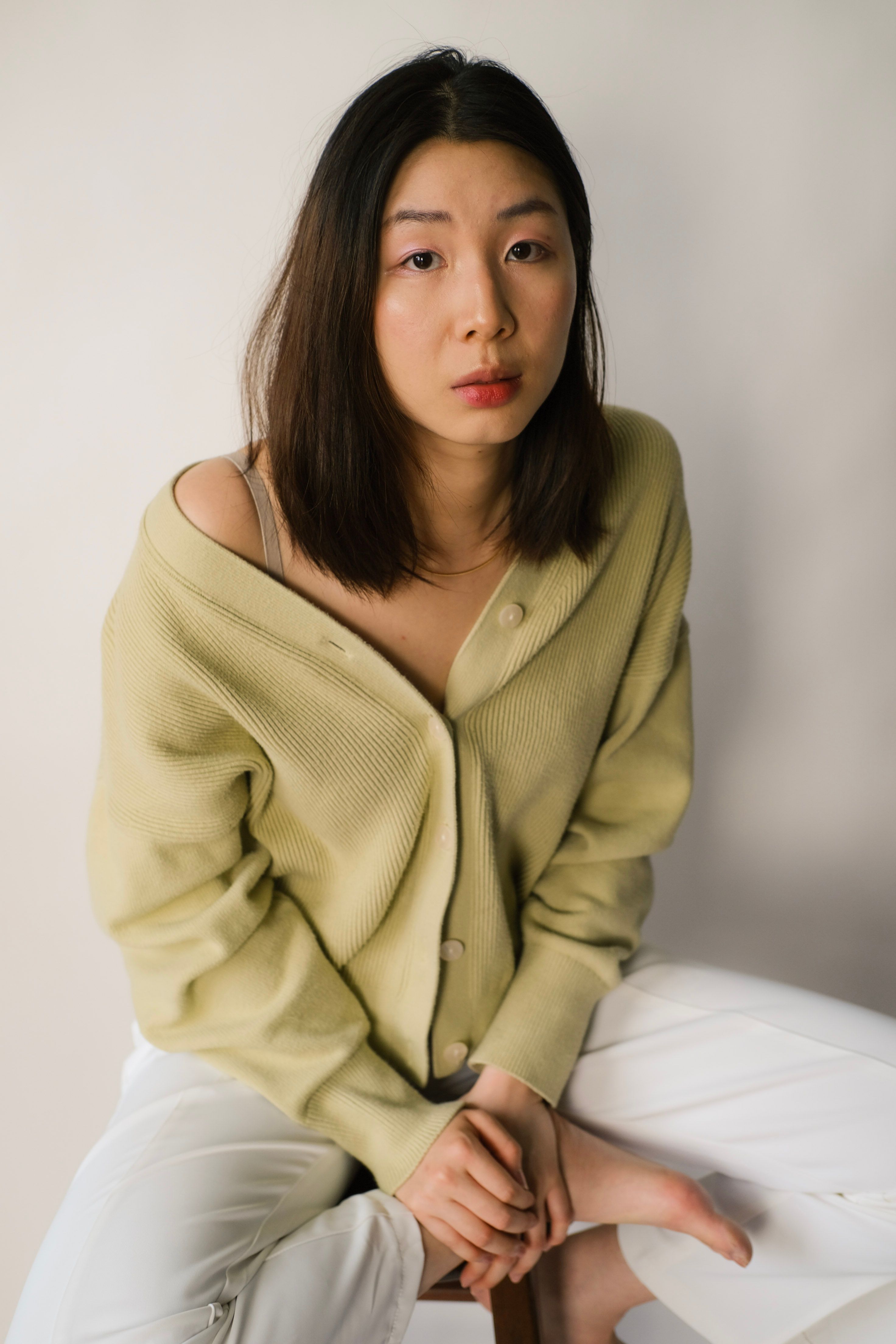 Portrait of a woman in a cozy cardigan, exuding a sense of calm and confidence.