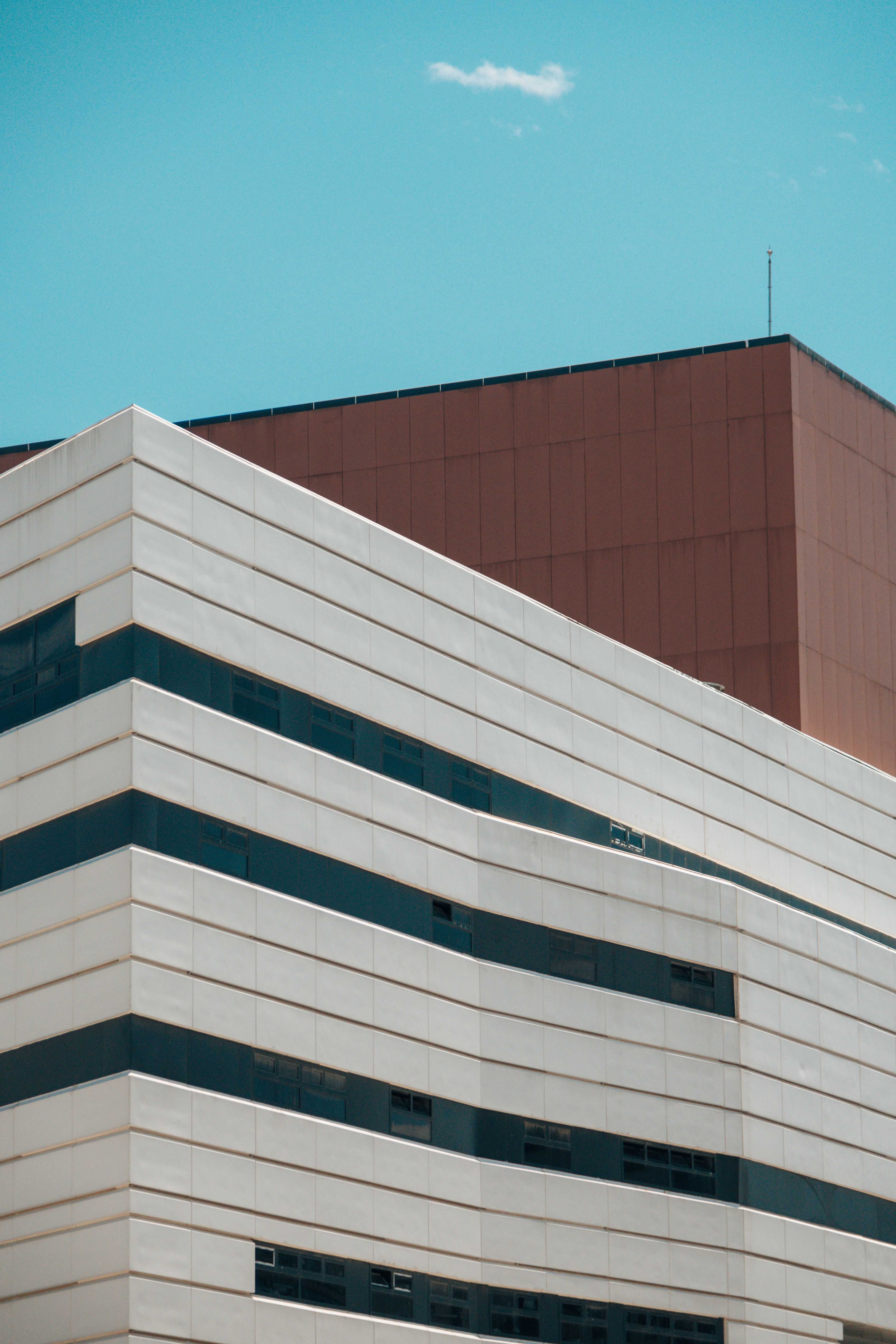 Low-Angle Shot of Two Buildings under the Blue Sky · Free Stock Photo