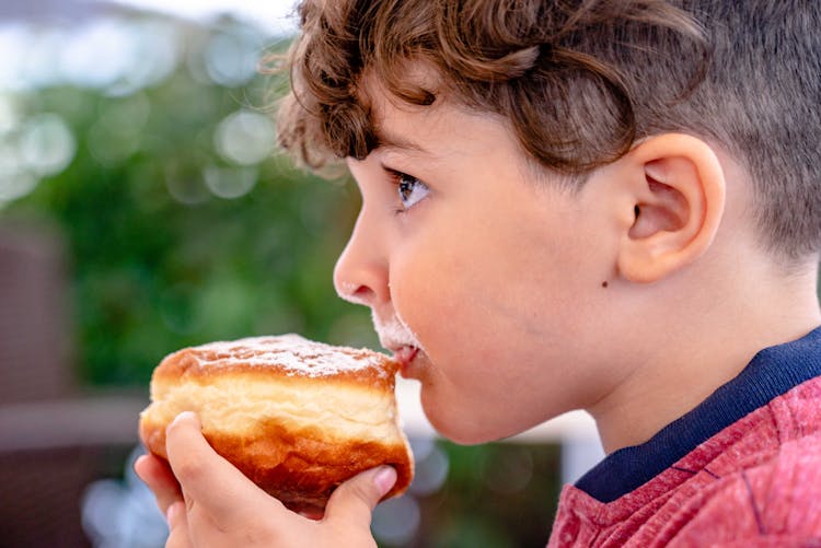 Boy Eating Bread In Close Up Photography