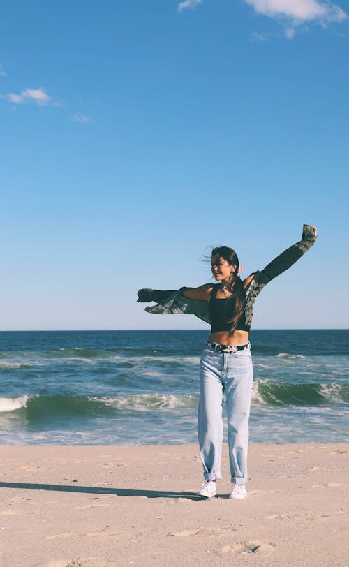 Woman in Black Tank Top Standing a the Beach