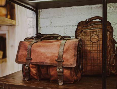 Brown Leather 2 Way Bag on Brown Wooden Table