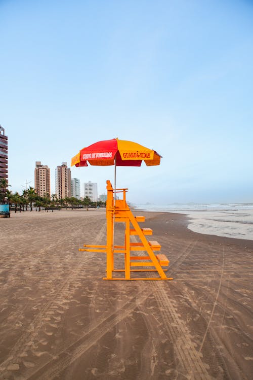 Free Umbrella on Top of a Lifeguard Post at the Beach Stock Photo