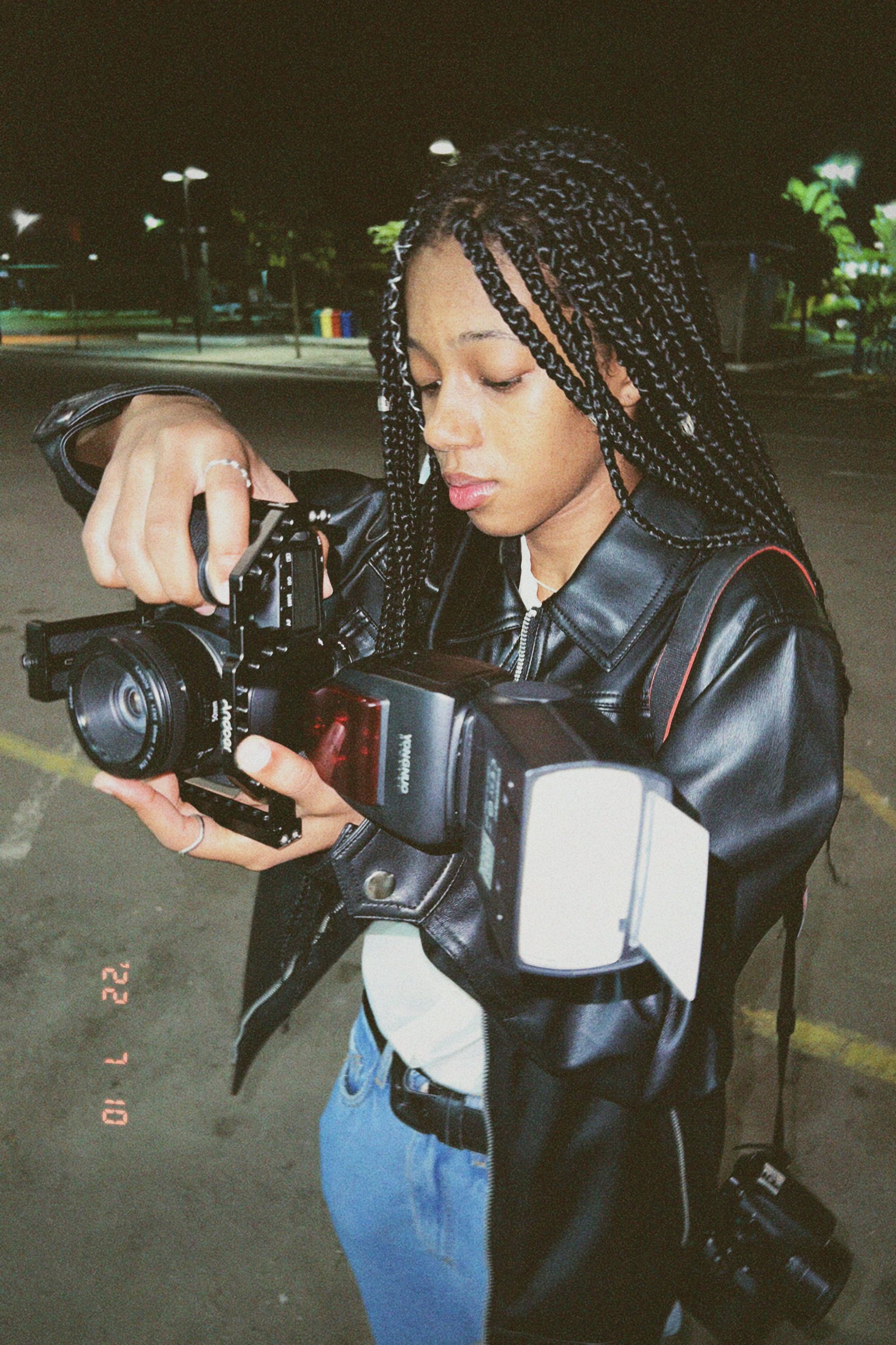 Close-Up Shot of a Woman in Black Leather Jacket Holding a Camera ...