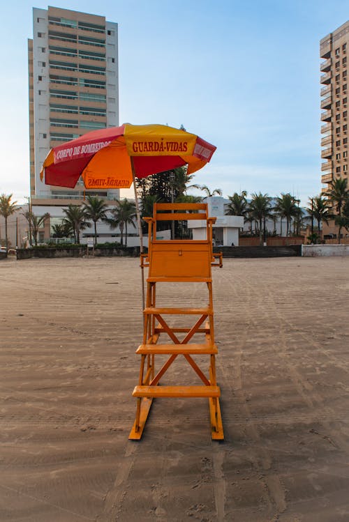 Yellow Wooden Lifeguard Post with a Beach Umbrella