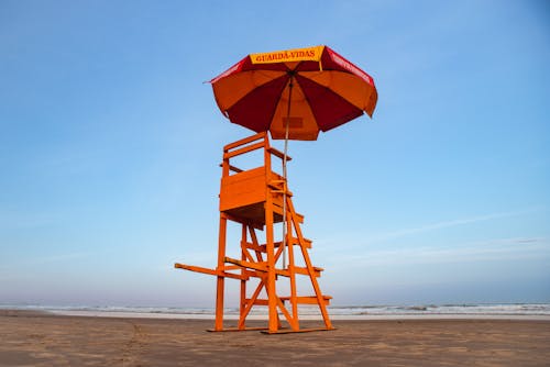 Free Yellow Wooden Lifeguard Post on Beach Shore Stock Photo