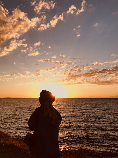 Woman Wearing Hijab on the Beach During Sunset