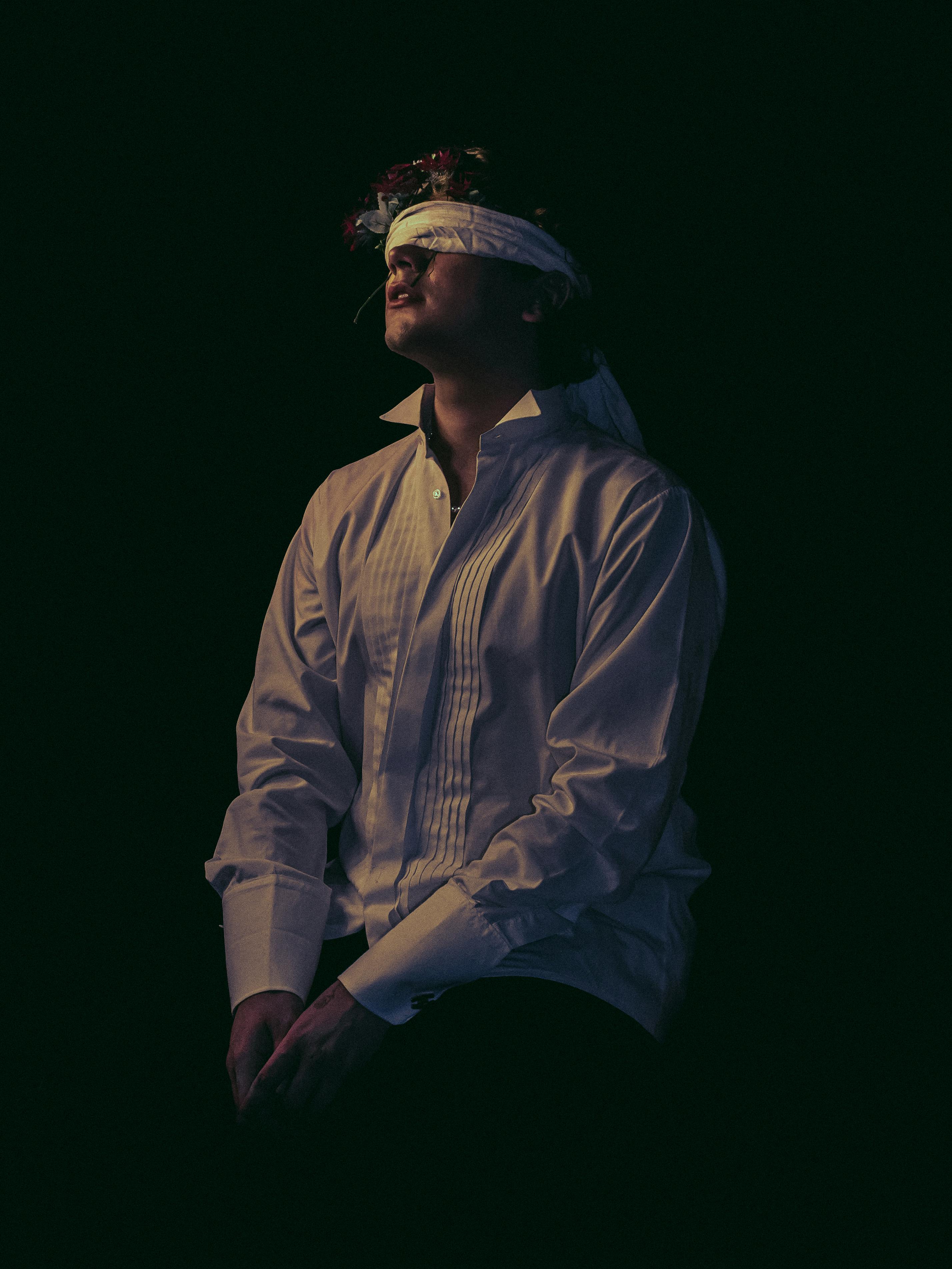 man with a blindfold in a dark room