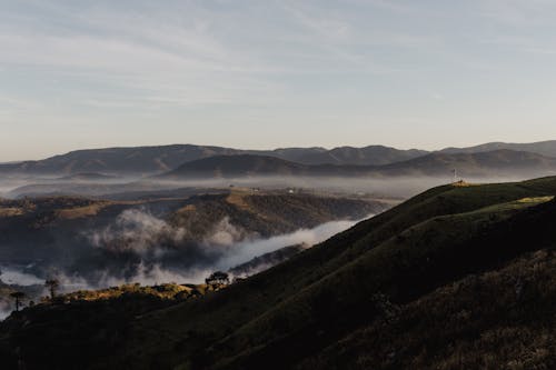 Aerial Photography of Cloudy Green Mountains under the Sky