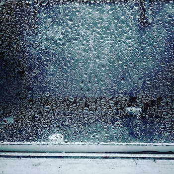 Close-up of raindrops on a windowpane in Berlin, capturing the texture and mood of a rainy day.
