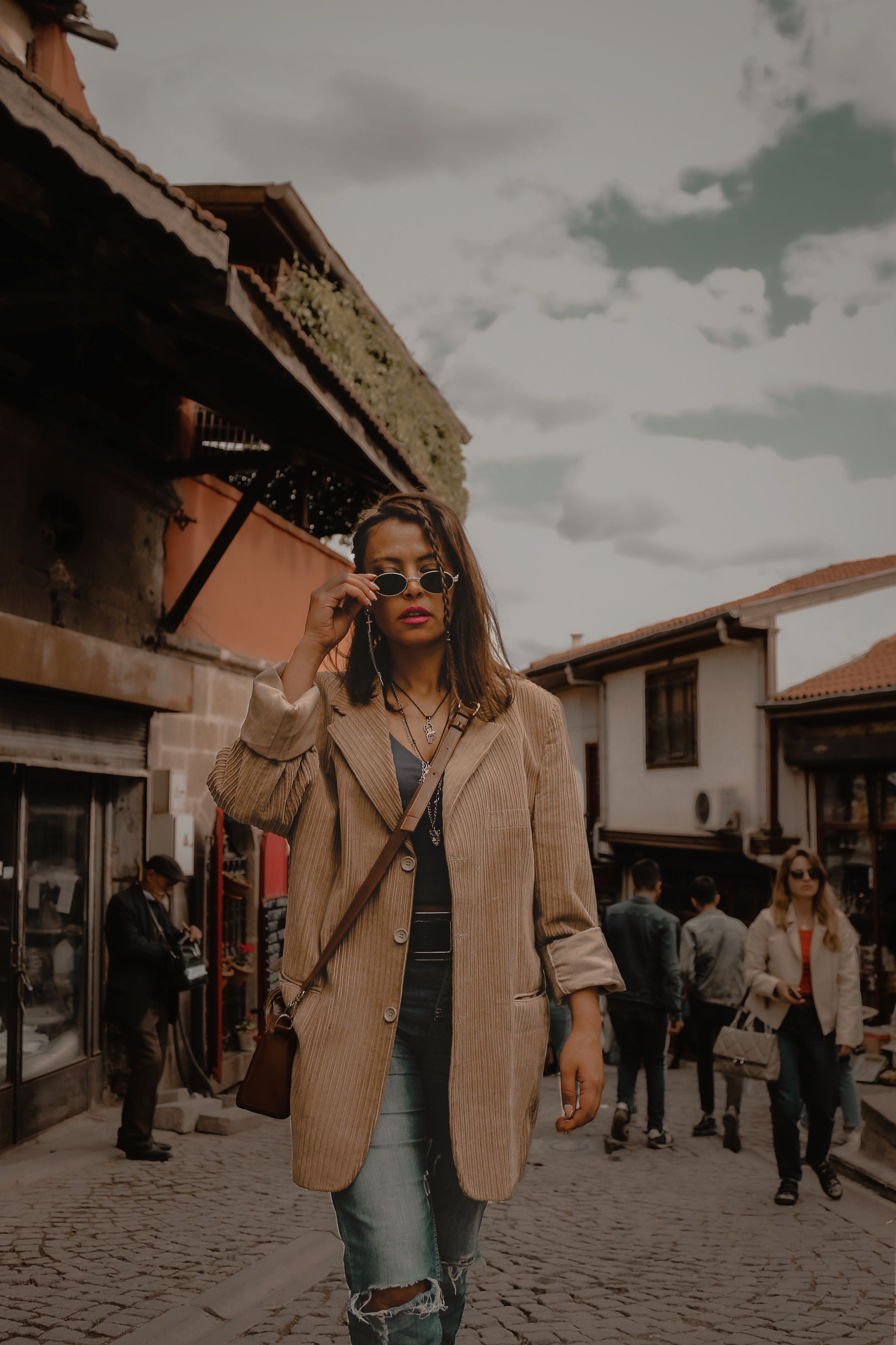 A Woman in a Black Coat Walking on a Street · Free Stock Photo