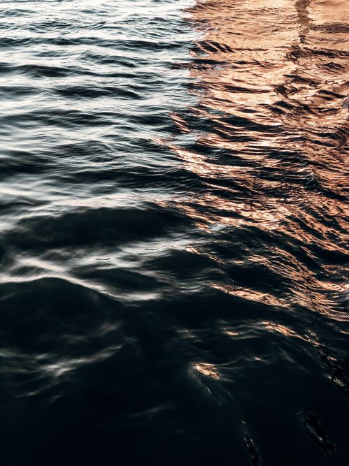 Free Calm water surface reflecting soft light patterns, creating a peaceful atmosphere. Stock Photo