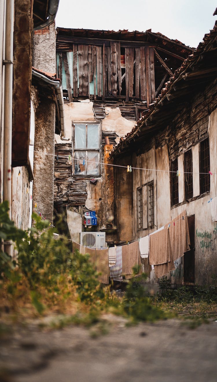 Old Crumbling Buildings By Narrow 