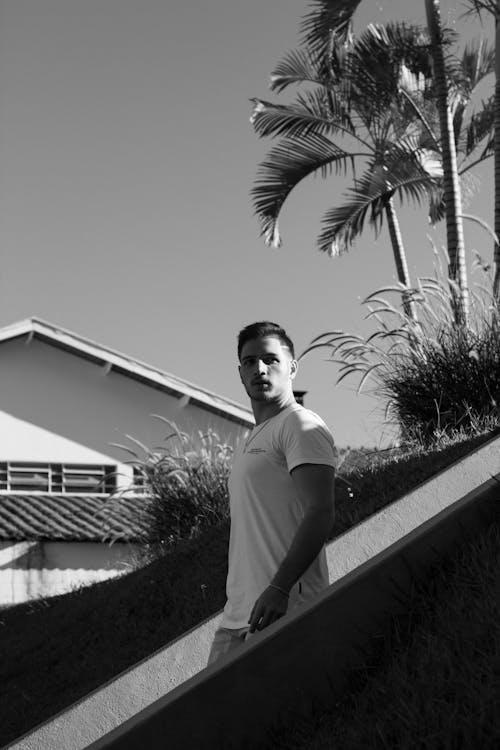 Man Standing Near Palm Trees