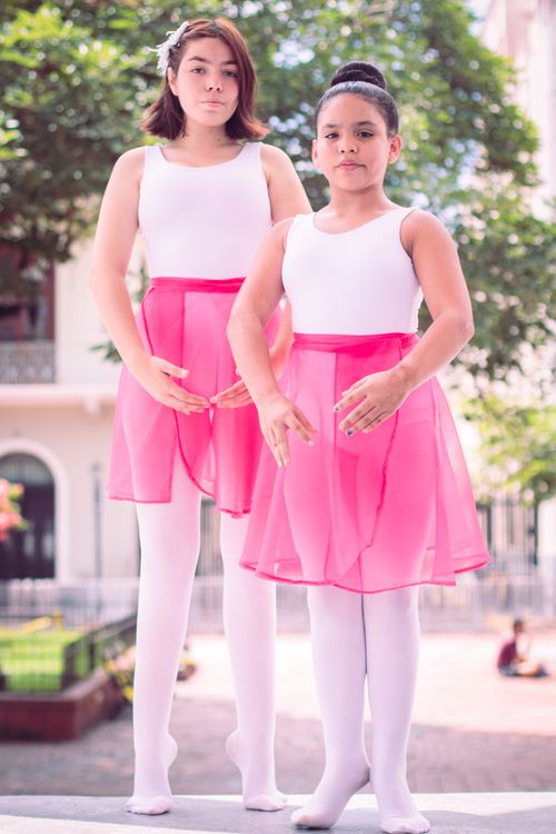 Free Two young ballerinas in pink tutus posing outdoors, exuding grace and poise. Stock Photo