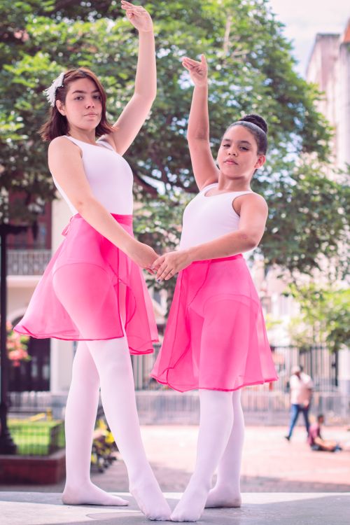 Free Two young ballet dancers posing gracefully in pink tutus outdoors. Stock Photo