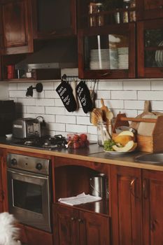 Warm and inviting wooden kitchen featuring rustic elements and fresh fruits.